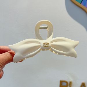 Chanel Bow Shark Hair Clip with Pearl Logo in PVC Beige