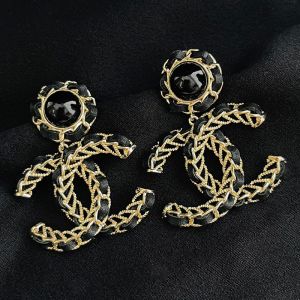 Chanel Pearl Woven Logo Earrings in Metal and Lambskin Black